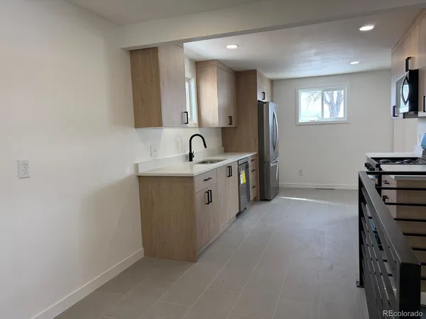 a kitchen with a sink stove and cabinets