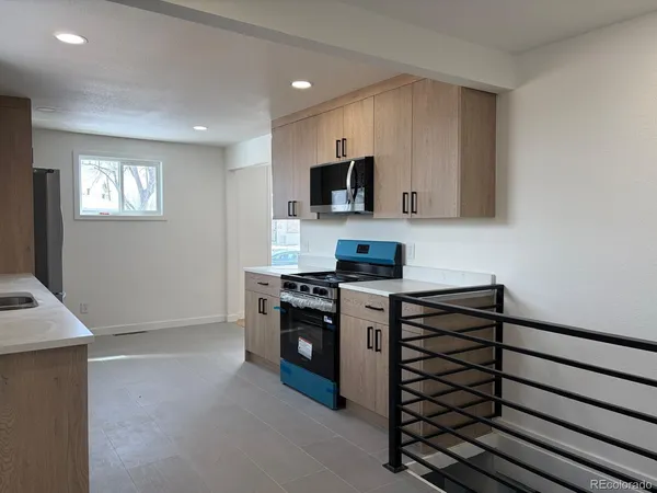 a kitchen with stainless steel appliances white cabinets and a stove top oven
