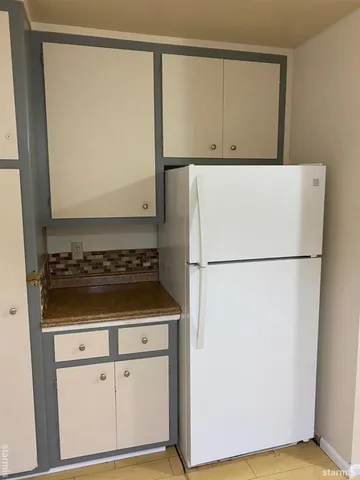 a view of a storage and utility room with washer and dryer