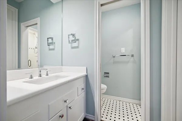 a roof deck with couches and wooden fence