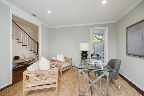 a dining room with furniture and wooden floor