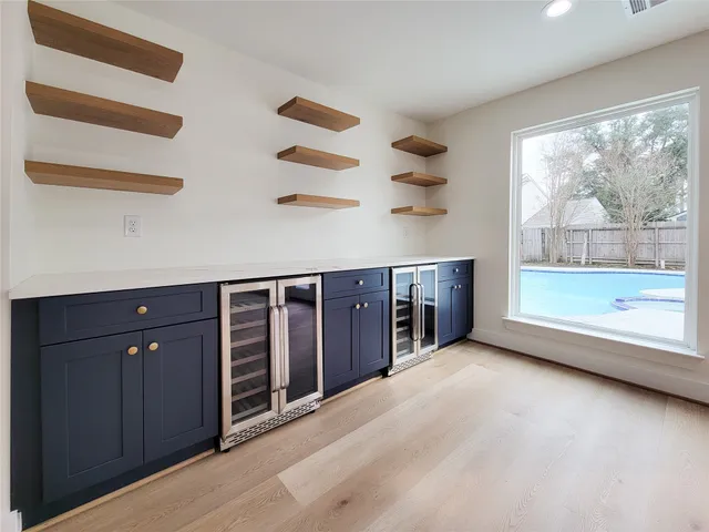 an empty room with a fireplace and large window