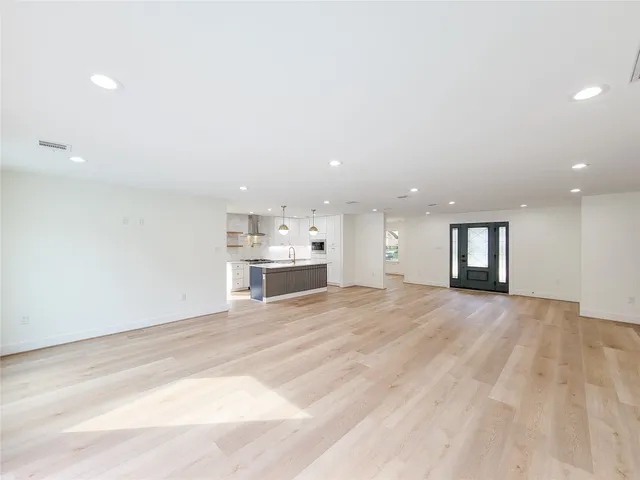 a kitchen with kitchen island granite countertop a sink a center island and stainless steel appliances