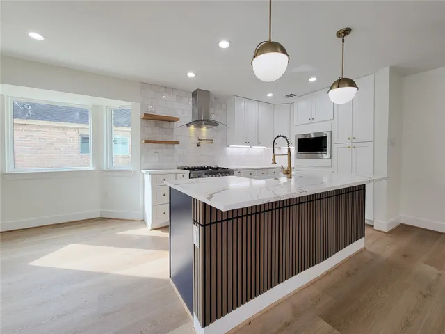 a kitchen with sink a stove and cabinets