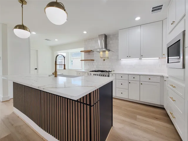 a kitchen with a stove a sink and a microwave
