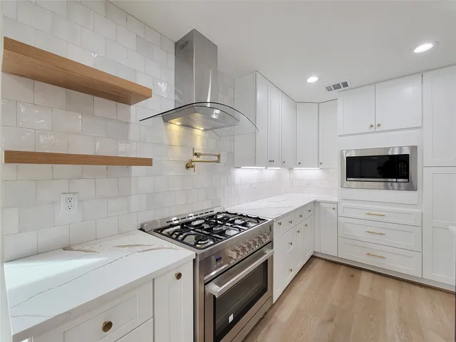 a kitchen with a sink and wooden floor