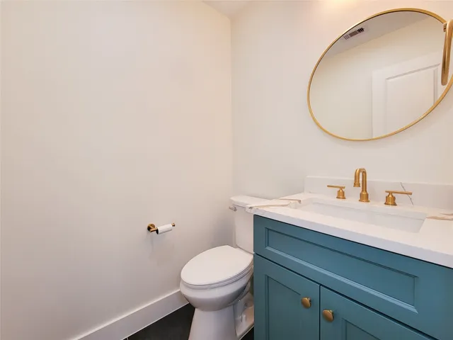 an empty room with wooden floor ceiling fan and windows