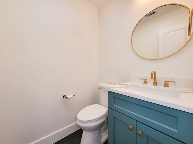 a bathroom with a sink a mirror and a toilet