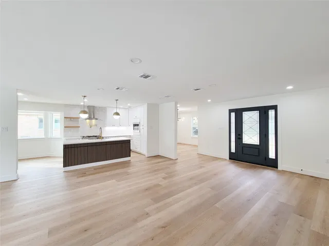 a view of a room with a window and wooden floor
