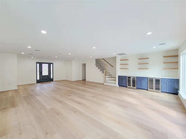 an empty room with a fireplace and large window