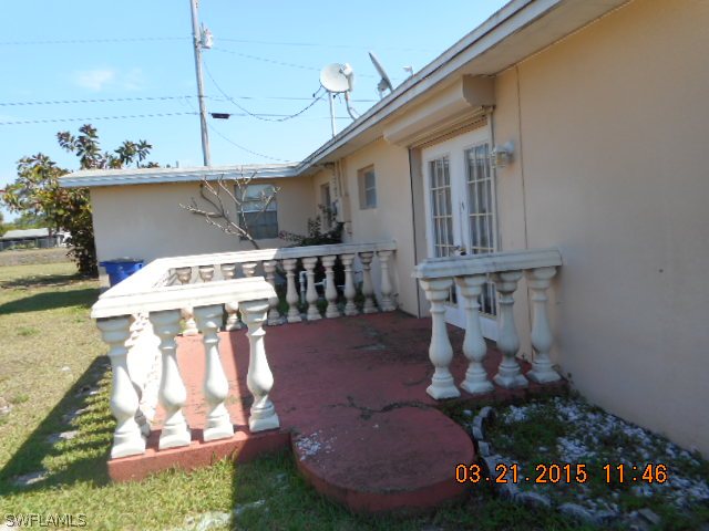 107 Davis Road Lehigh Acres, FL 33936 - Photo 2 of 9 a view of a house with backyard and sitting area