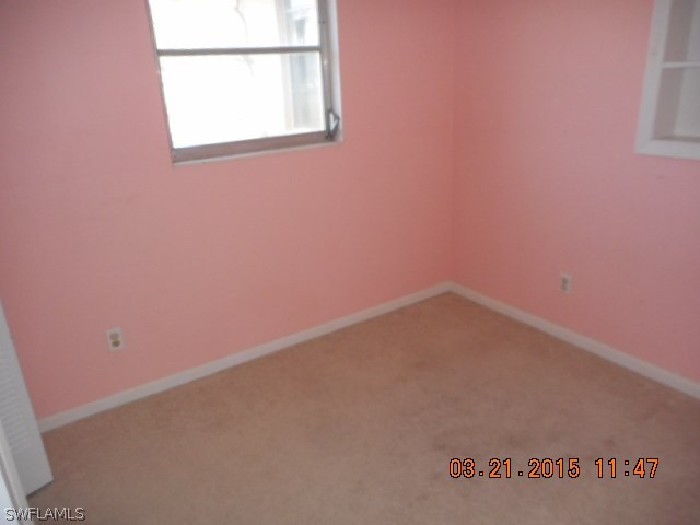 107 Davis Road Lehigh Acres, FL 33936 - Photo 5 of 9 an empty room with a window
