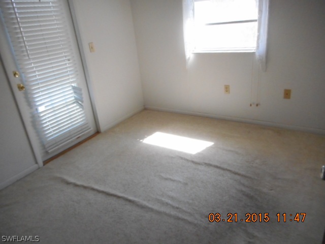 107 Davis Road Lehigh Acres, FL 33936 - Photo 6 of 9 an empty room with windows