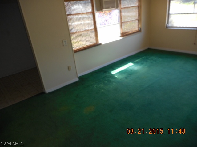 107 Davis Road Lehigh Acres, FL 33936 - Photo 8 of 9 a view of an empty room with window