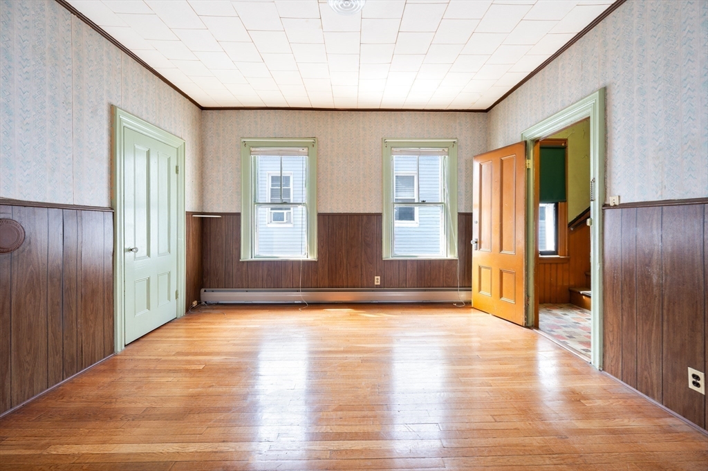 545 2nd Street Fall River, MA 02721 - Photo 11 of 22 a view of an empty room with window and wooden floor