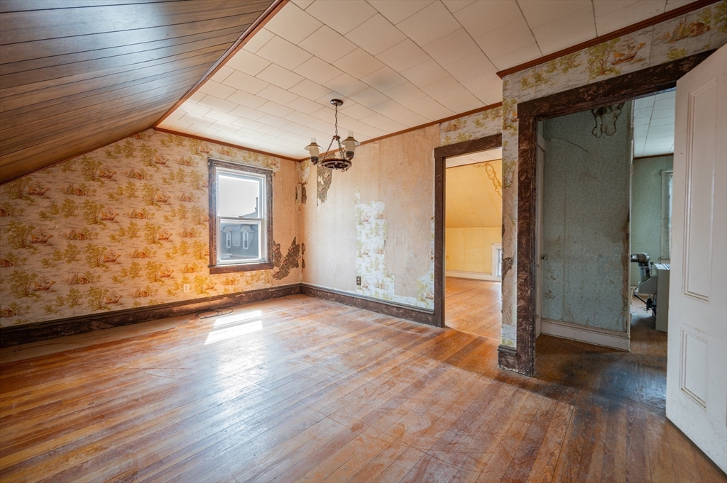 545 2nd Street Fall River, MA 02721 - Photo 15 of 22 an empty room with wooden floor and windows