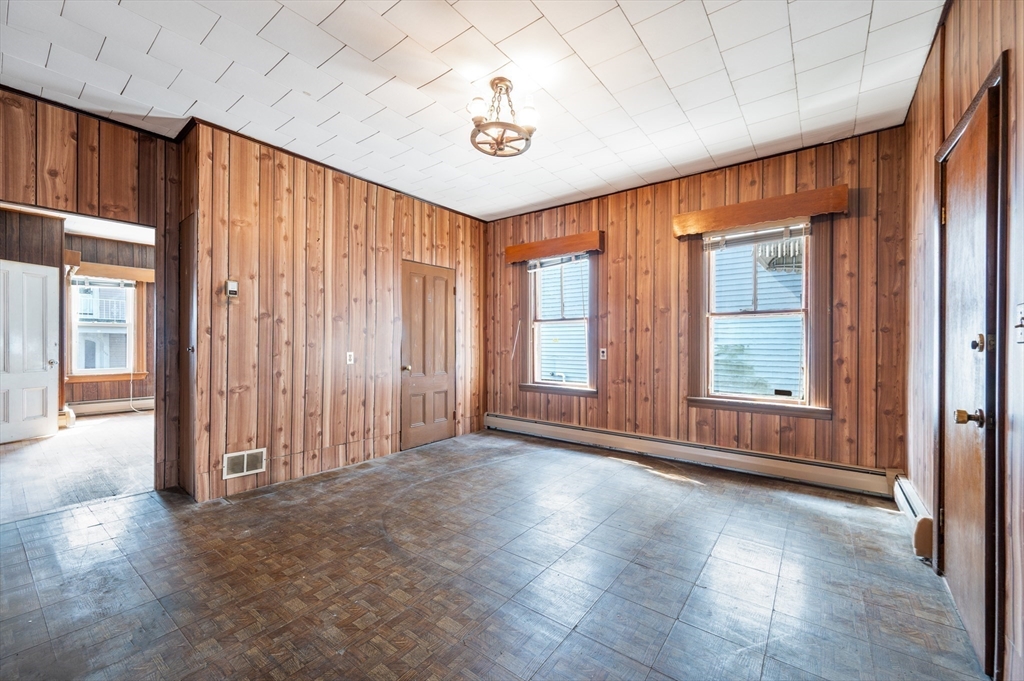 545 2nd Street Fall River, MA 02721 - Photo 5 of 22 an empty room with wooden floor and windows