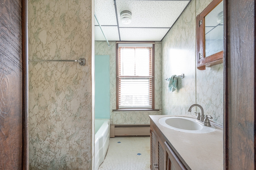 545 2nd Street Fall River, MA 02721 - Photo 7 of 22 a bathroom with a sink a toilet and a shower