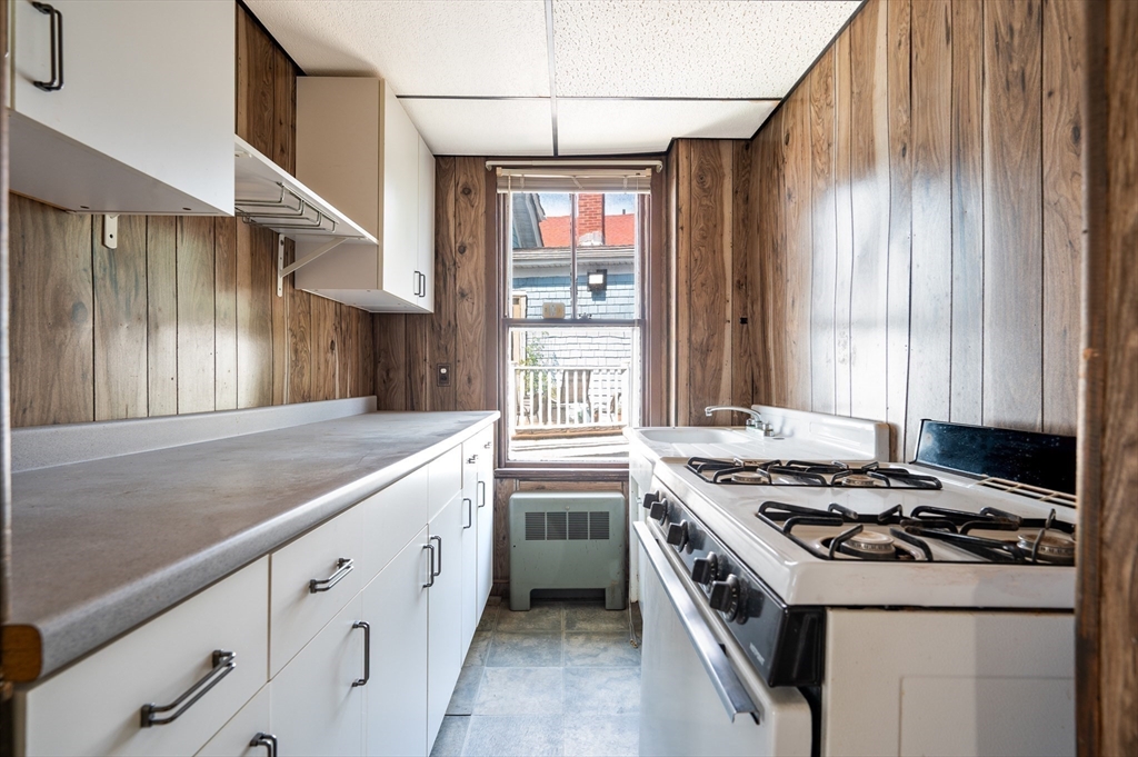 545 2nd Street Fall River, MA 02721 - Photo 10 of 22 a kitchen with stainless steel appliances granite countertop a stove and a sink