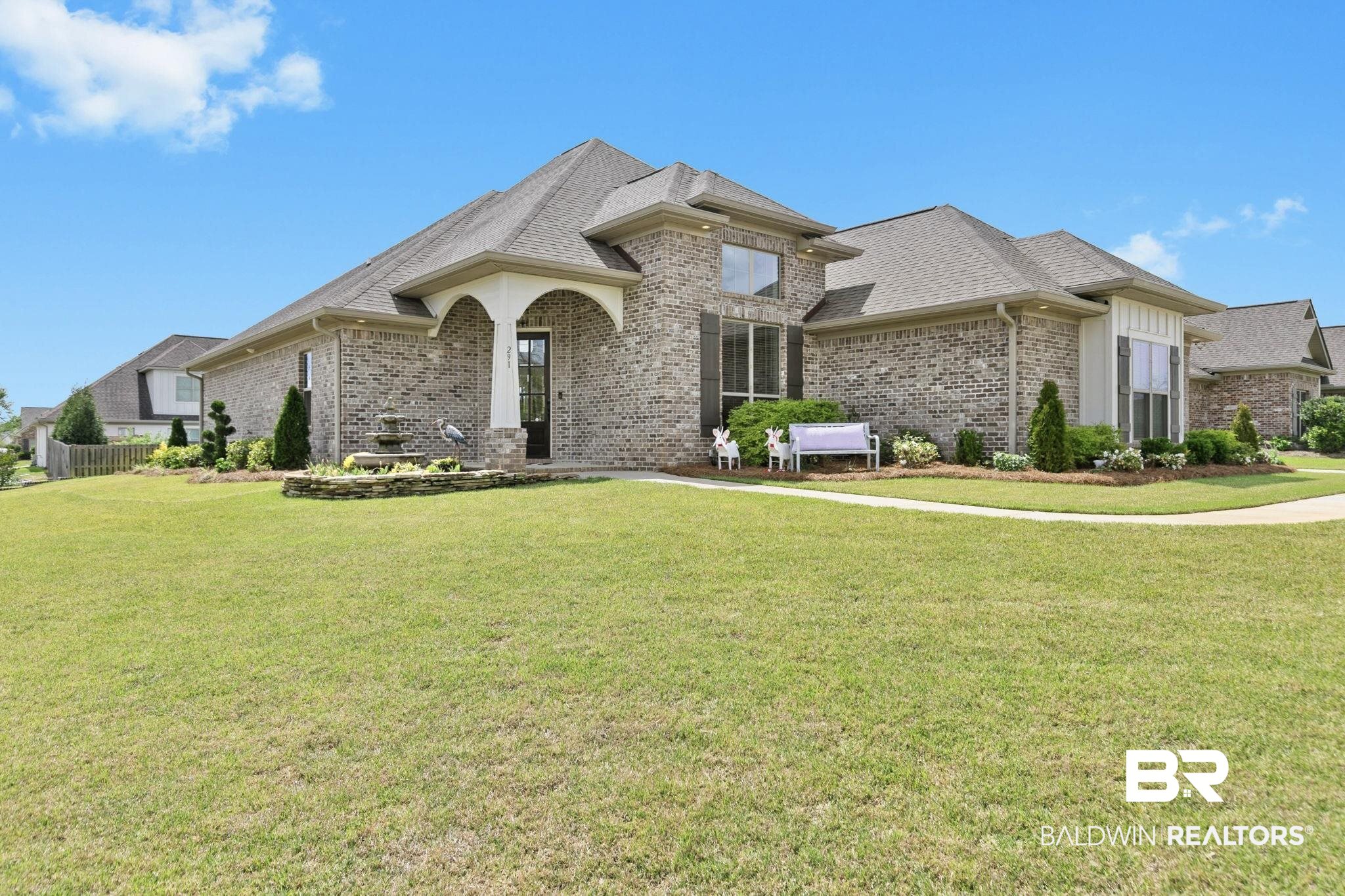 291 Hemlock Drive Fairhope, AL 36532 - Photo 1 of 65 French country inspired facade with a front lawn, brick siding, and roof with shingles