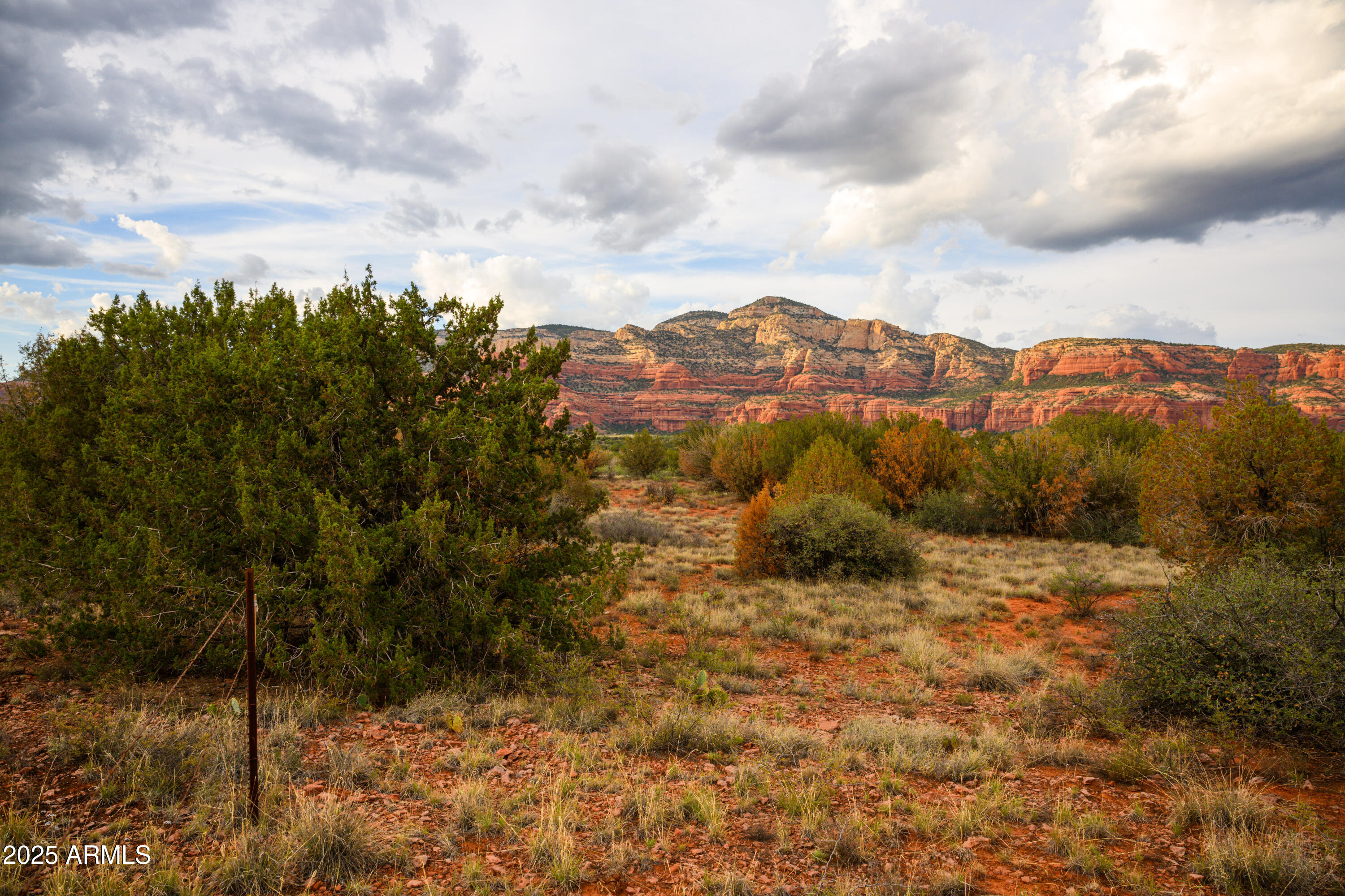 55 Estrella Road, Unit 5 Sedona, AZ 86336 - Photo 37 of 61 a view of a field with a tree in the background
