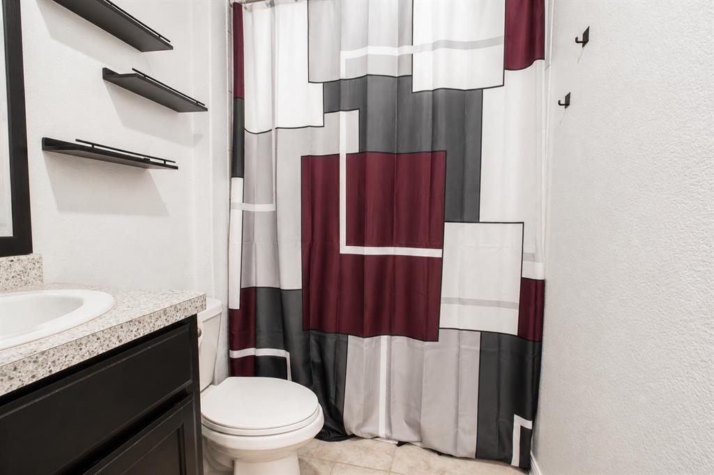 3204 Quiet Valley Road Fort Worth, TX 76123 - Photo 8 of 29 a bathroom with a sink a toilet and shower