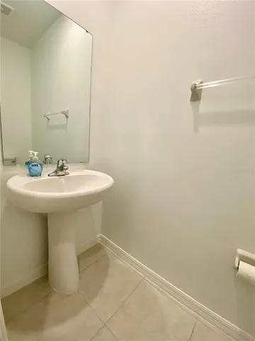 a bathroom with a sink a mirror and a toilet