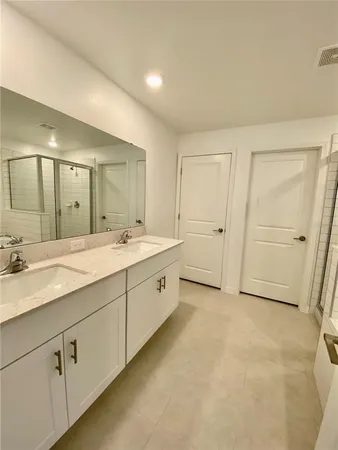 a spacious bathroom with a double vanity sink mirror and
