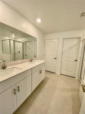 a spacious bathroom with a double vanity sink mirror and