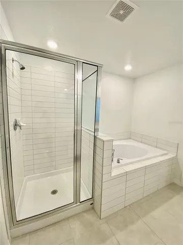 a bathroom with a shower and a tub