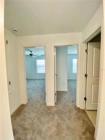 an empty room with windows and bathroom view