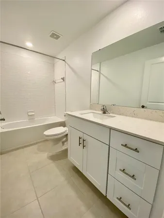 a bathroom with a sink a toilet and bathtub
