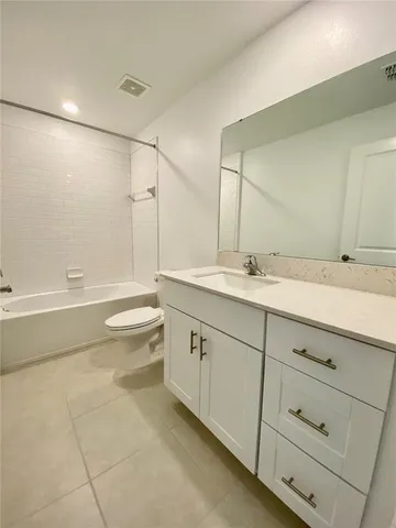 a bathroom with a sink a toilet and bathtub