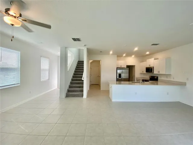 a view of a kitchen with a sink and a living room view