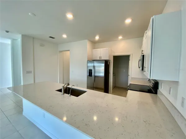 a kitchen with a refrigerator and a sink