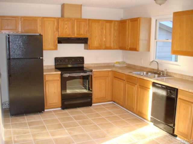 1205 Martin Pond Road Wendell, NC 27591 - Photo 3 of 10 New Kitchen w/ real tile floors, upgraded lighting & black appliances incl a refrigerator. Other