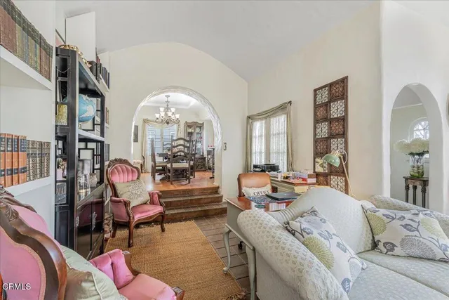 a living room with furniture a rug and a window