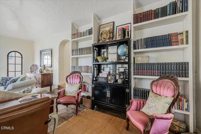 a view of a dining room with furniture a chandelier and wooden floor