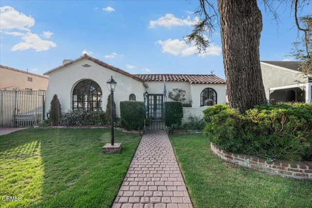 a view of a white house with a yard