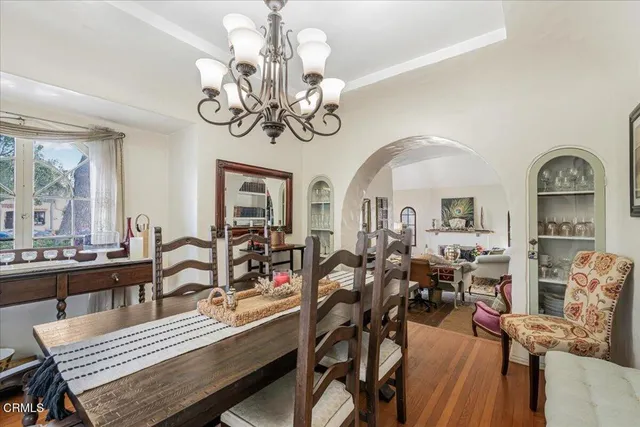 a view of hall way with furniture and chandelier