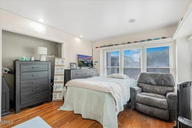 a living room with furniture and a book shelf