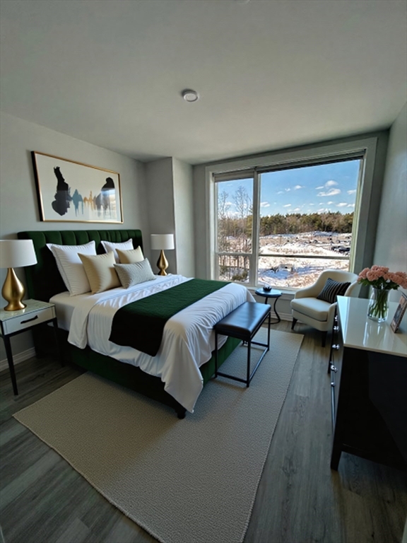 a bedroom with a bed couch and a large window