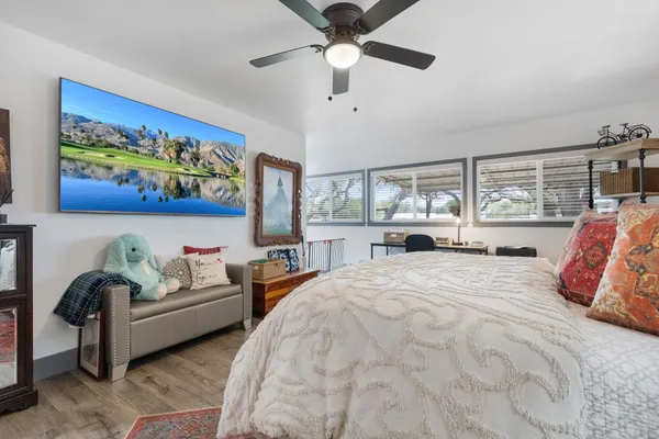 a bedroom with a bed furniture and a large window