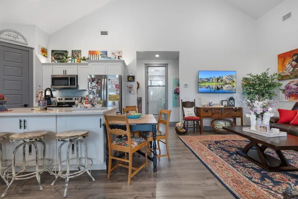 a living room with lots of furniture and kitchen view