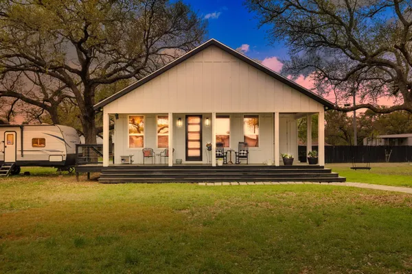 a view of a house with backyard porch and sitting area