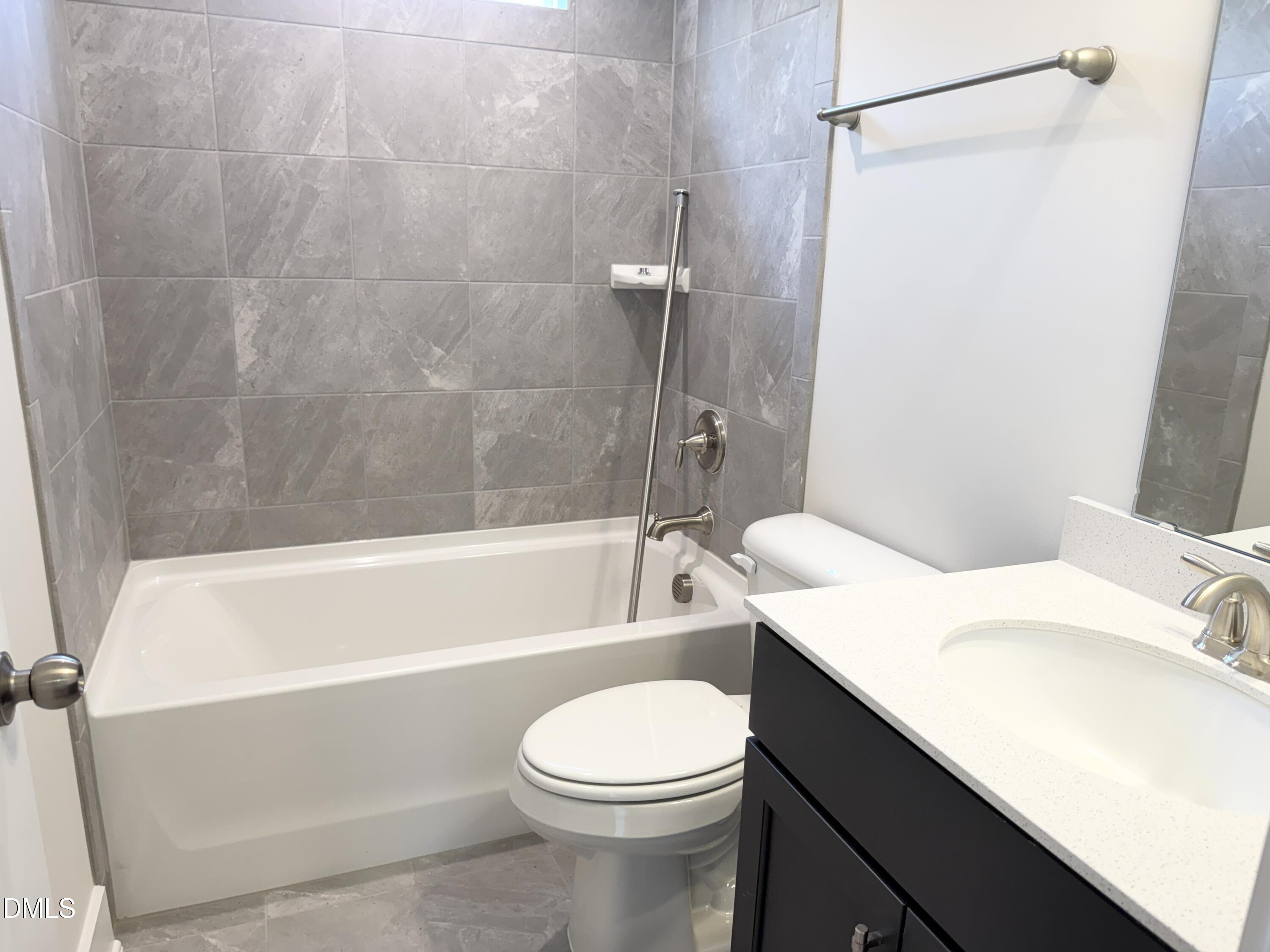 1122 Berkeley Street Durham, NC 27705 - Photo 22 of 29 a bathroom with a sink a toilet and a bathtub