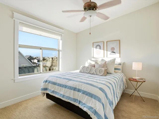 a bedroom with a bed and a painting on the wall