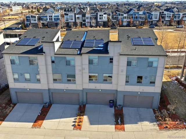 an aerial view of a house with parking space
