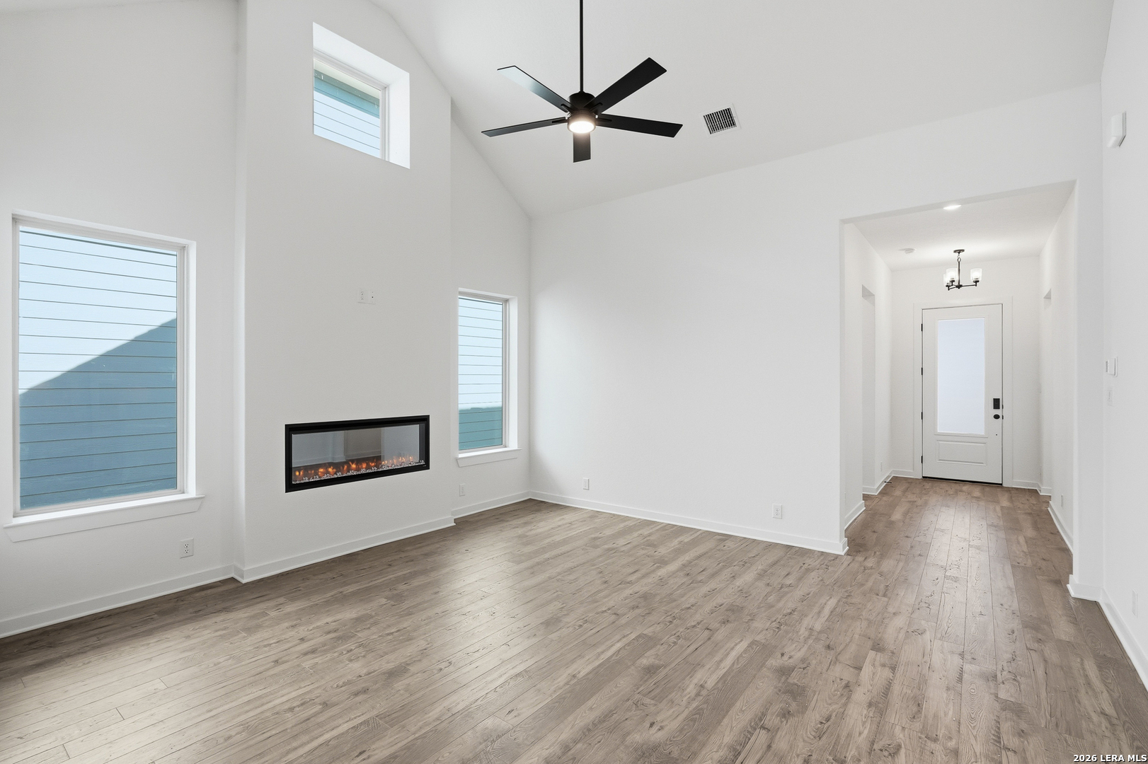 9414 Chatside Schertz, TX 78154 - Photo 11 of 37 a view of a livingroom with wooden floor a ceiling fan and windows