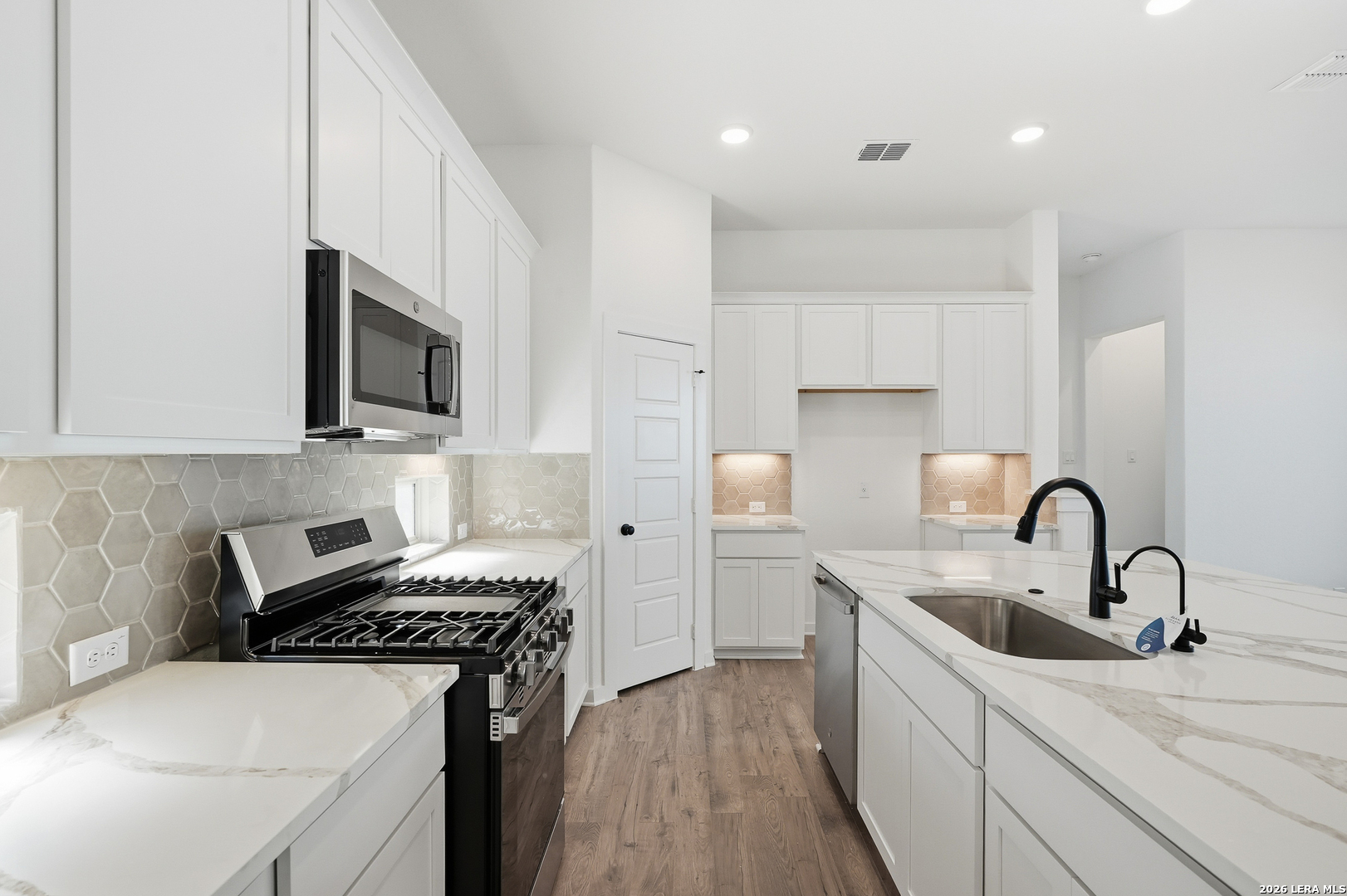 9414 Chatside Schertz, TX 78154 - Photo 16 of 37 a kitchen with a sink a stove and cabinets